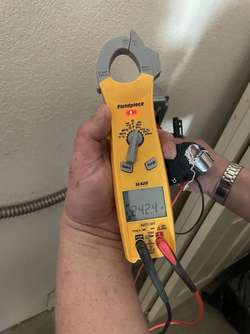 Voltage testing with clamp meter during Whole House Surge Protector in Gulf Shores